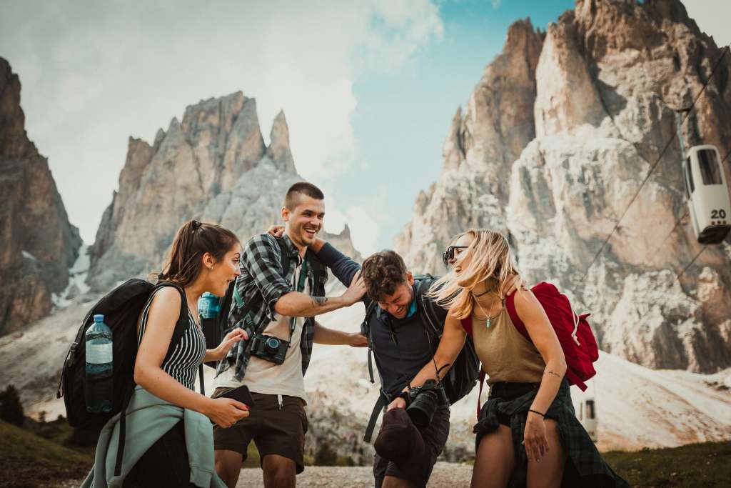 The picture is a group of friends in nature. The picture is there to show how meeting new people can better your Roadtrip