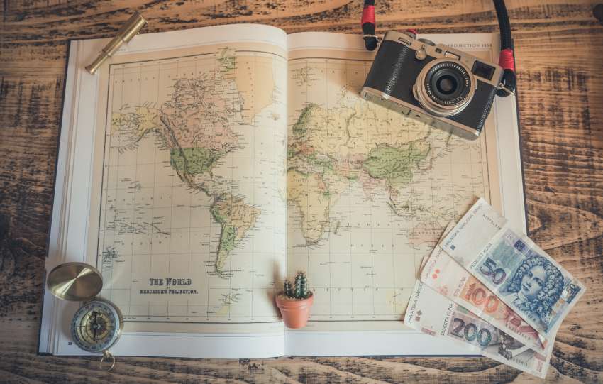 The picture displays money and a map of the world. It shows a prized possession to emphasize how important it is to obtain good insurance for adequate coverage.